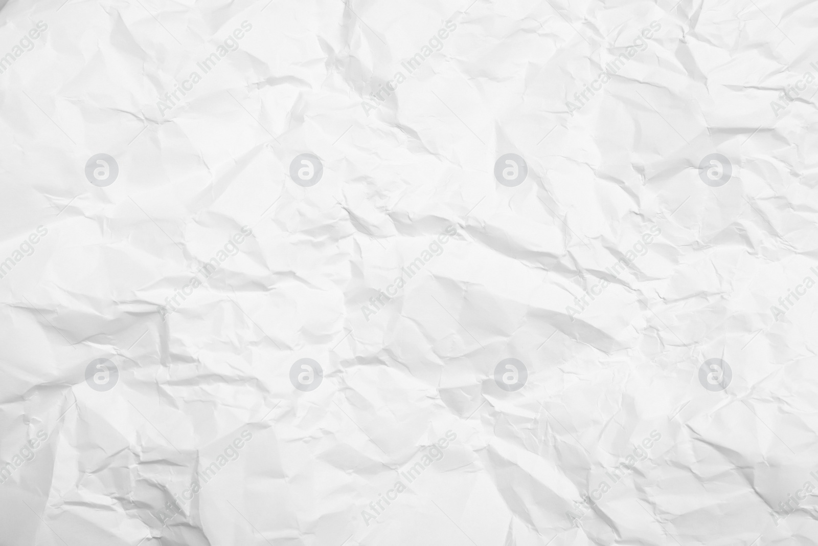 Photo of Sheet of white crumpled paper as background, closeup