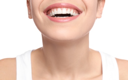 Photo of Young woman with beautiful smile on white background, closeup. Teeth whitening