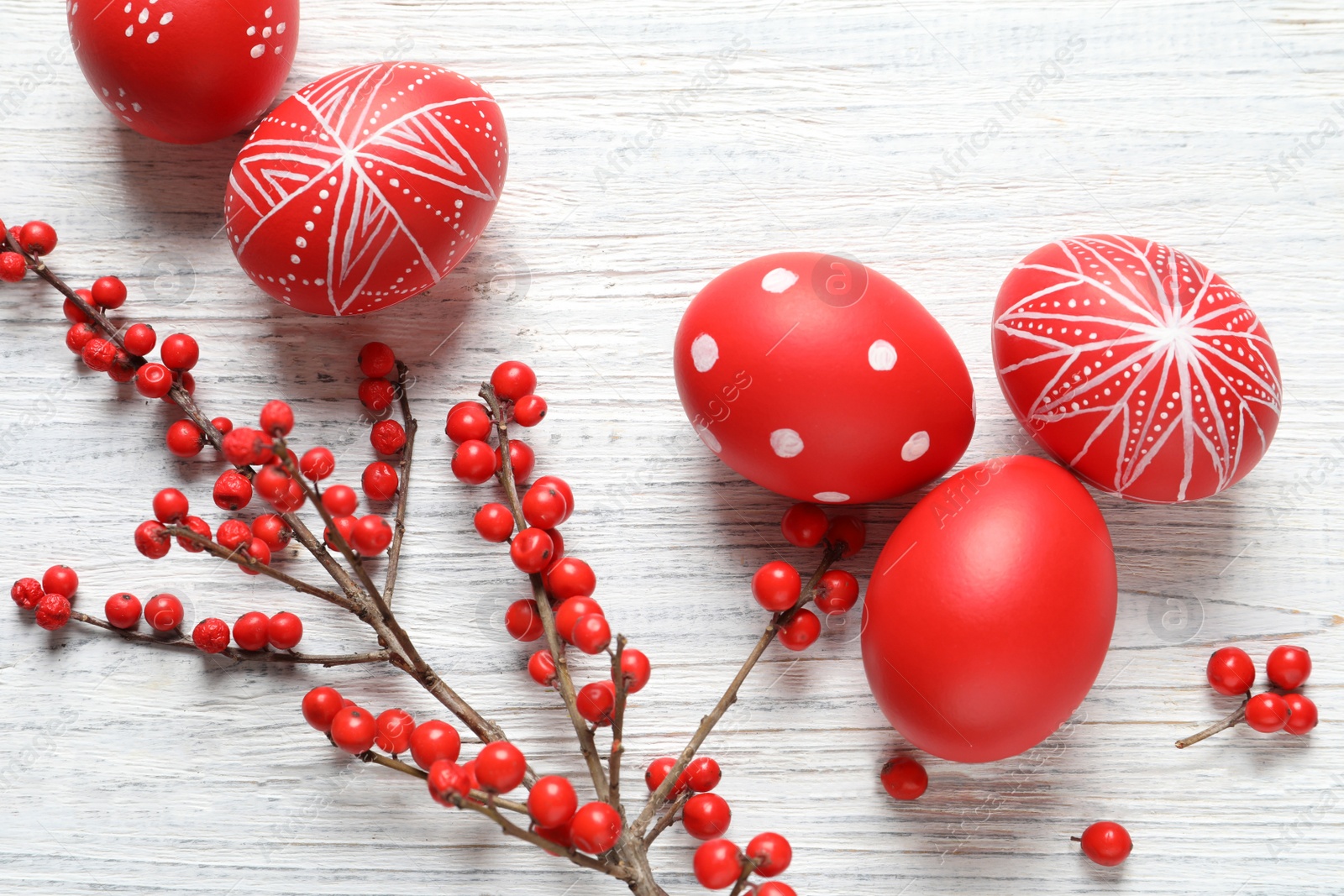 Photo of Flat lay composition of painted Easter eggs on wooden table