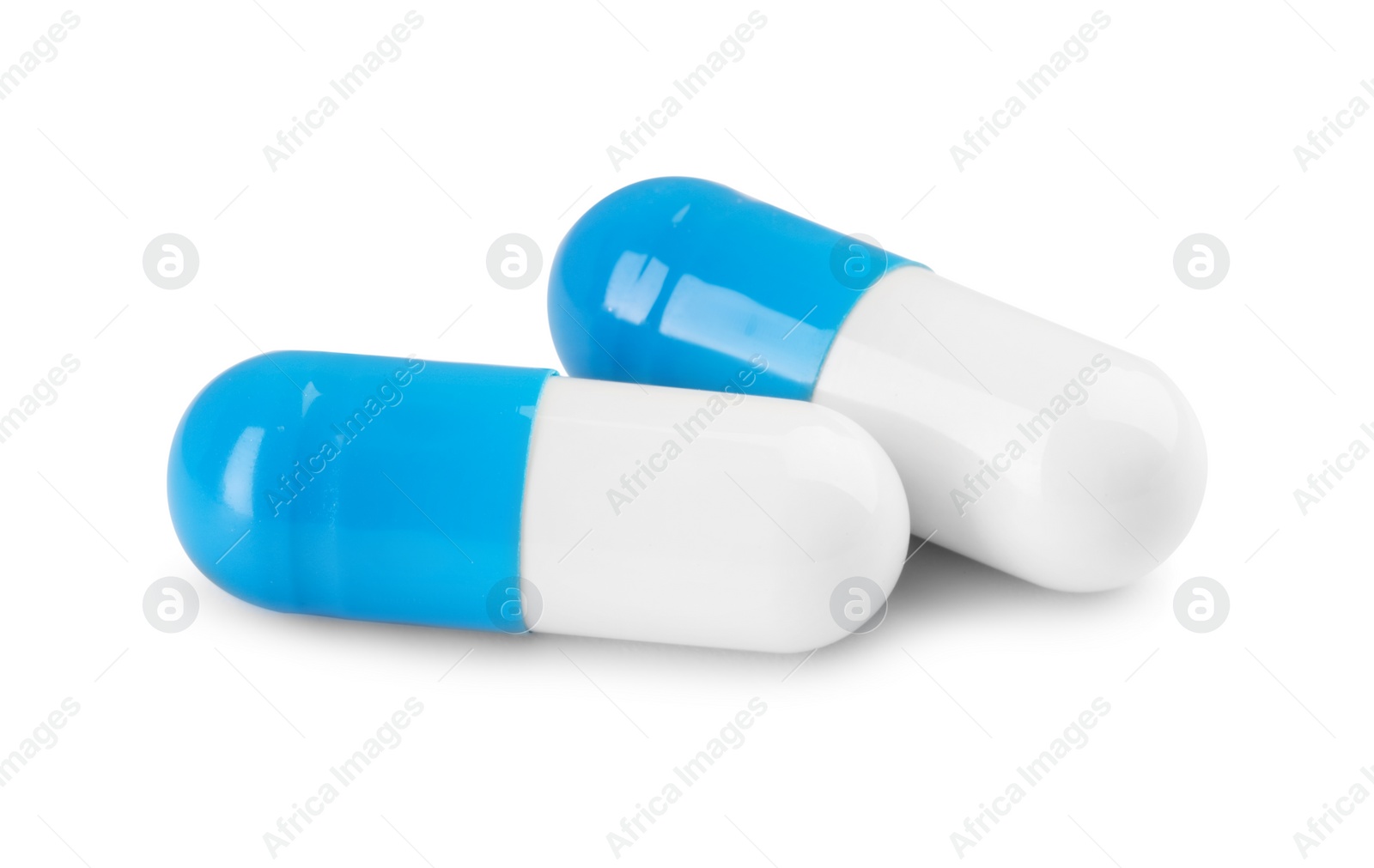 Photo of Two antibiotic pills isolated on white. Medicinal treatment