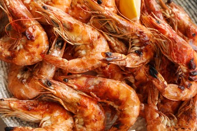 Photo of Delicious cooked shrimps on plate, top view