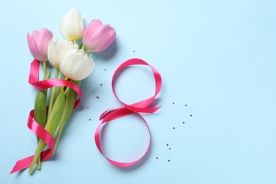 Photo of 8th of March greeting card design with pink ribbon, beautiful flowers and space for text on light blue background, flat lay. International Women's day