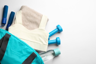 Flat lay composition with gym bag and sportswear on white background