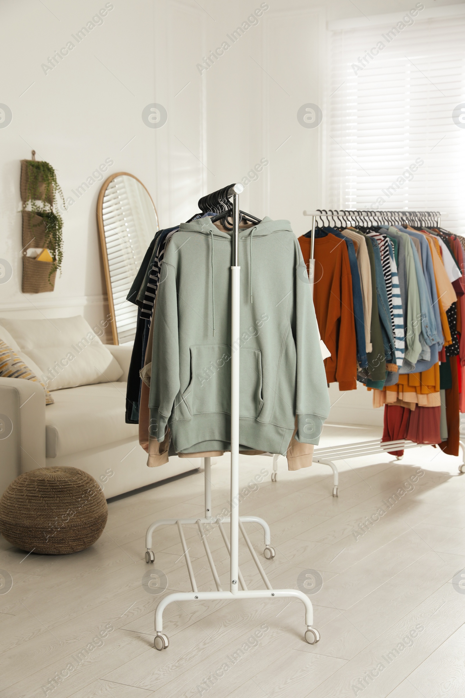 Photo of Racks with stylish clothes indoors. Fast fashion