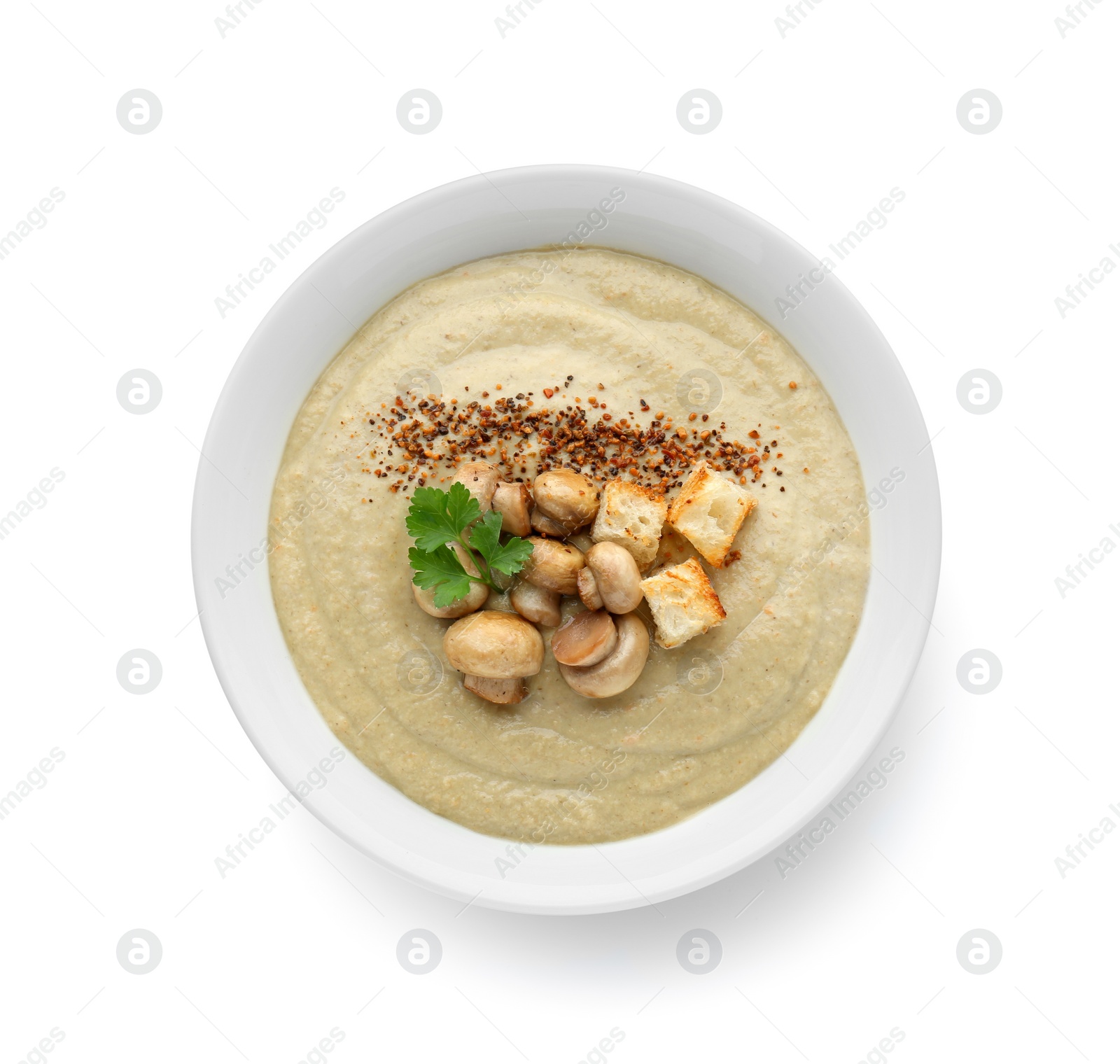 Photo of Delicious cream soup with mushrooms and croutons on white background, top view