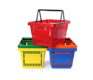 Colorful plastic shopping baskets on white background