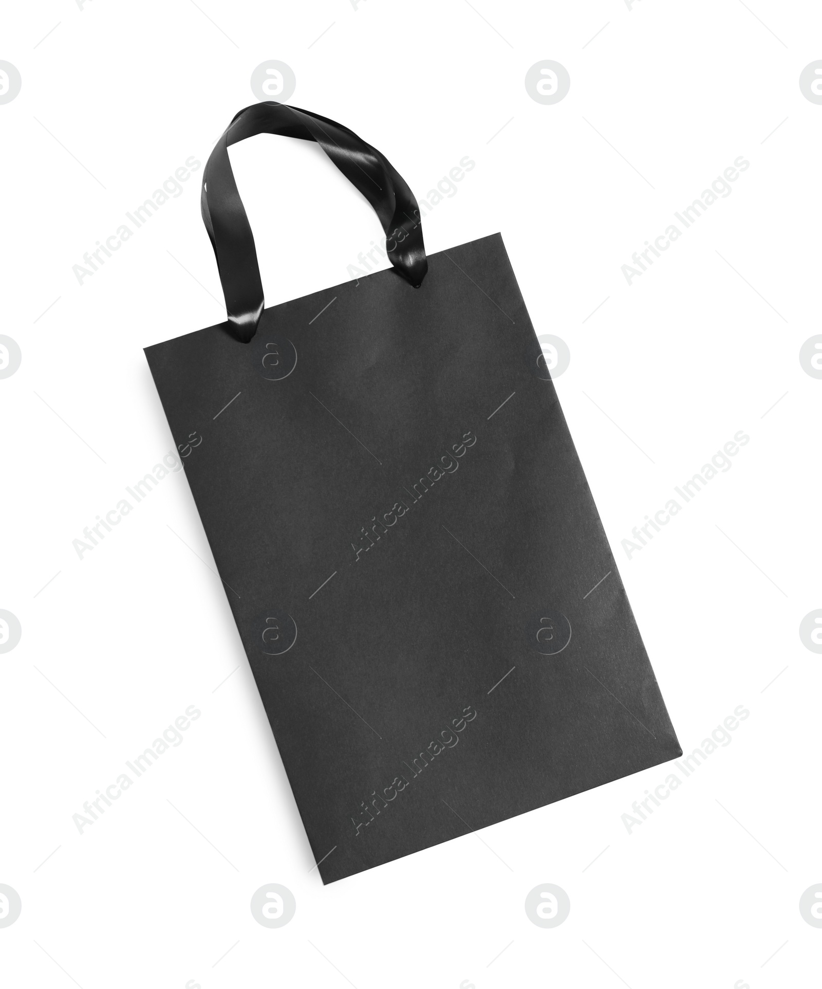 Photo of One black paper shopping bag on white background, top view. Space for text