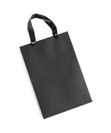 Photo of One black paper shopping bag on white background, top view. Space for text