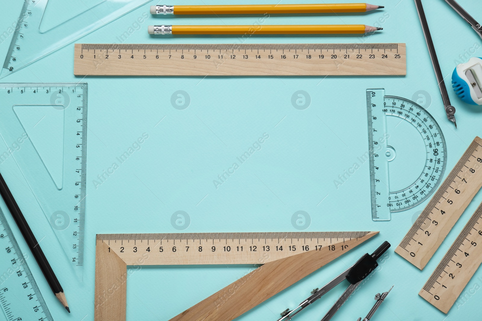 Photo of Flat lay composition with different rulers and protractor on turquoise background. Space for text