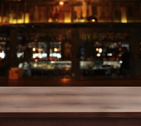 Image of Empty wooden surface and blurred view of bar interior. Space for design