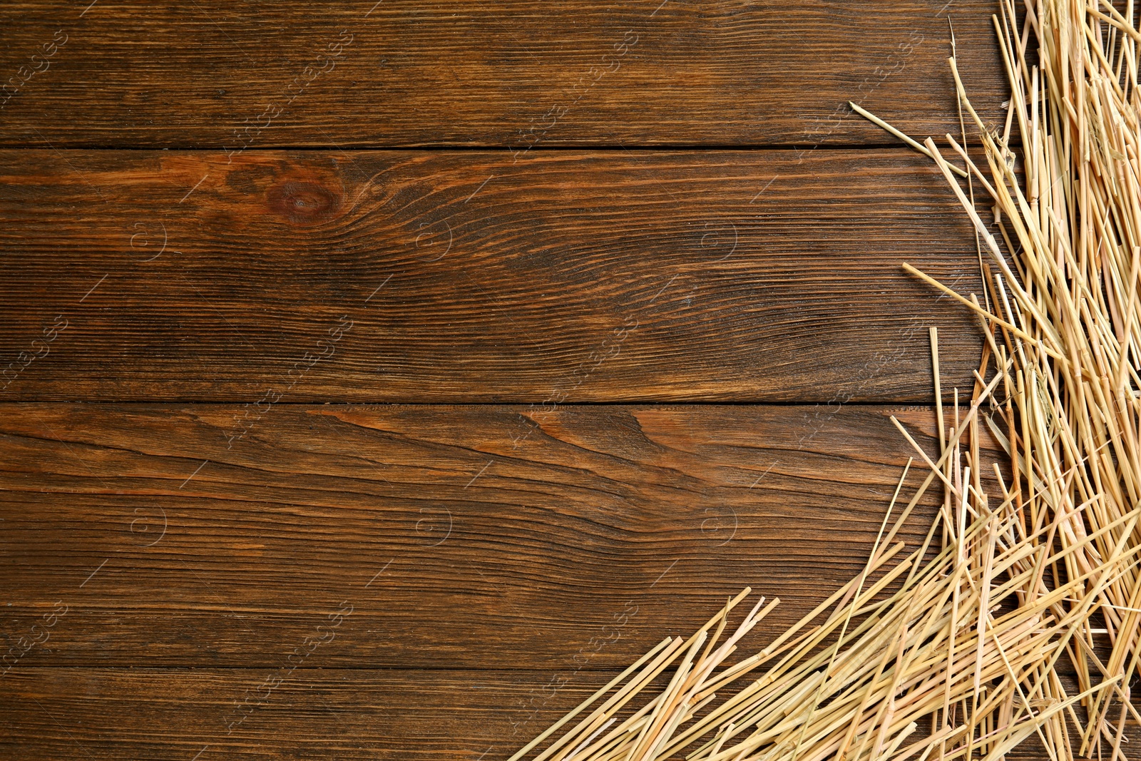 Photo of Dried hay on wooden background, flat lay. Space for text