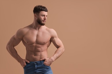 Photo of Handsome muscular man on beige background, space for text. Sexy body