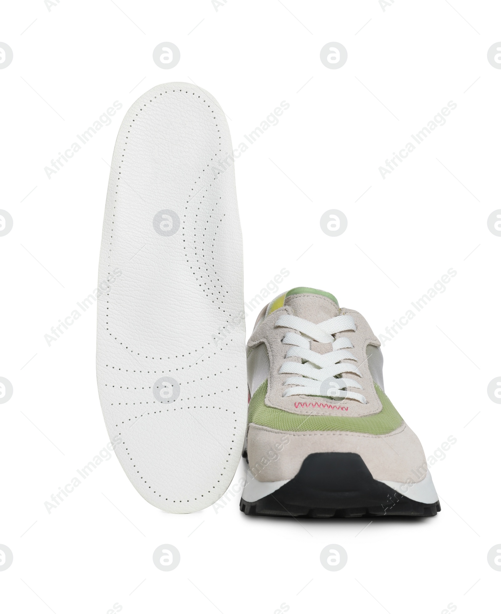 Photo of Orthopedic insole near shoe on white background