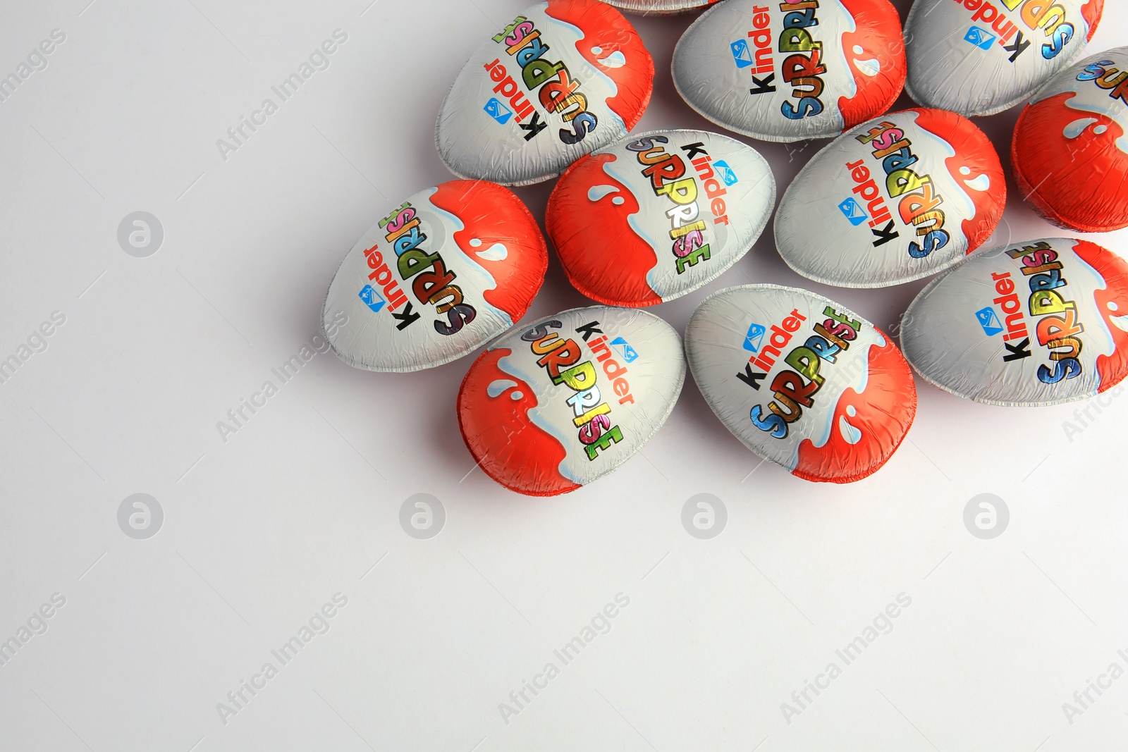 Photo of Sveti Vlas, Bulgaria - June 26, 2023: Kinder Surprise Eggs on white background, flat lay. Space for text