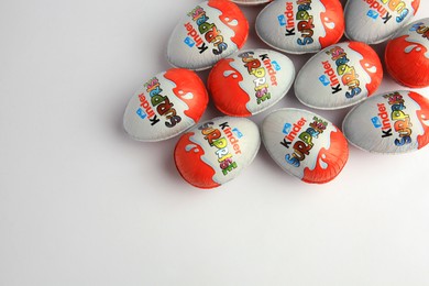 Photo of Sveti Vlas, Bulgaria - June 26, 2023: Kinder Surprise Eggs on white background, flat lay. Space for text