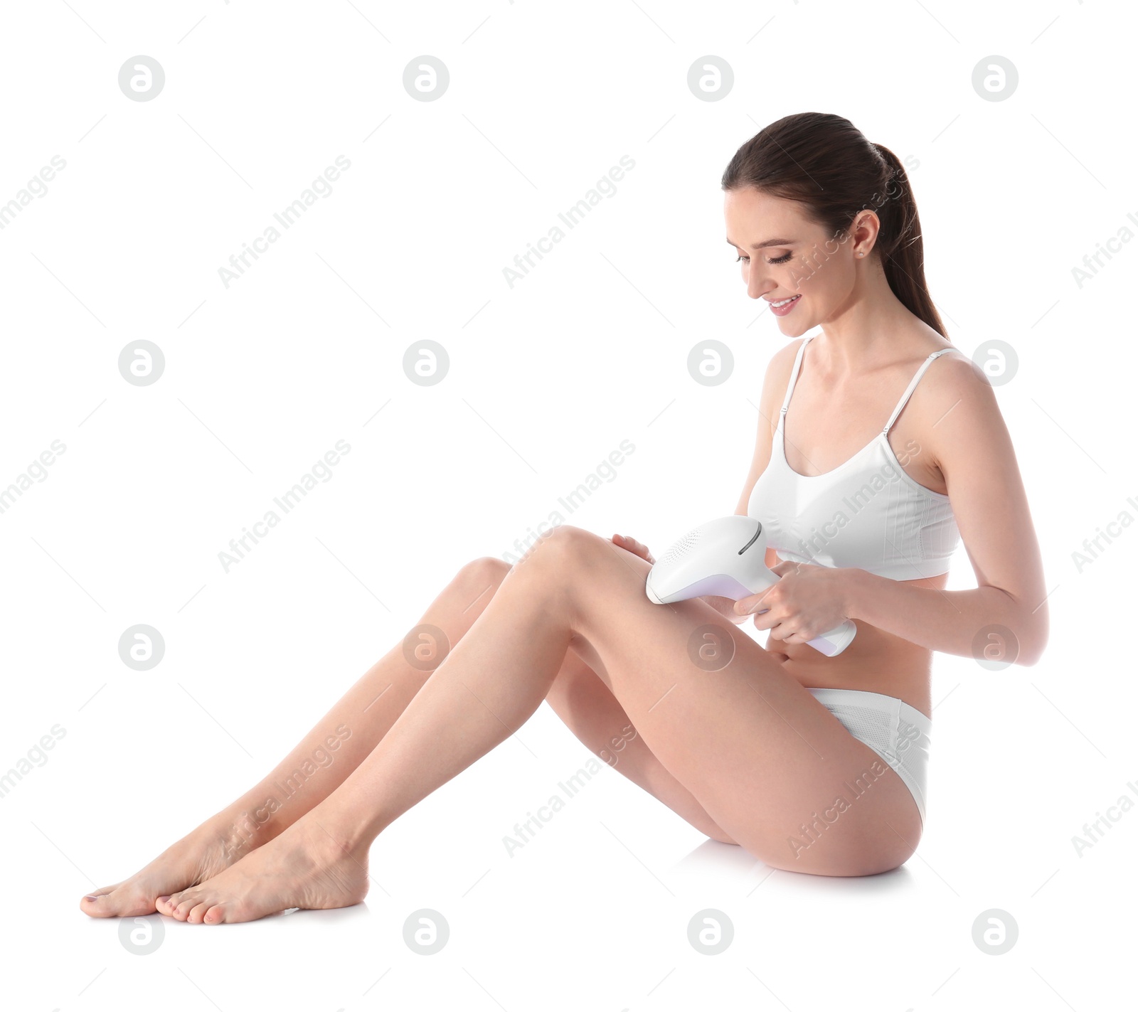 Photo of Young woman doing leg epilation procedure on white background