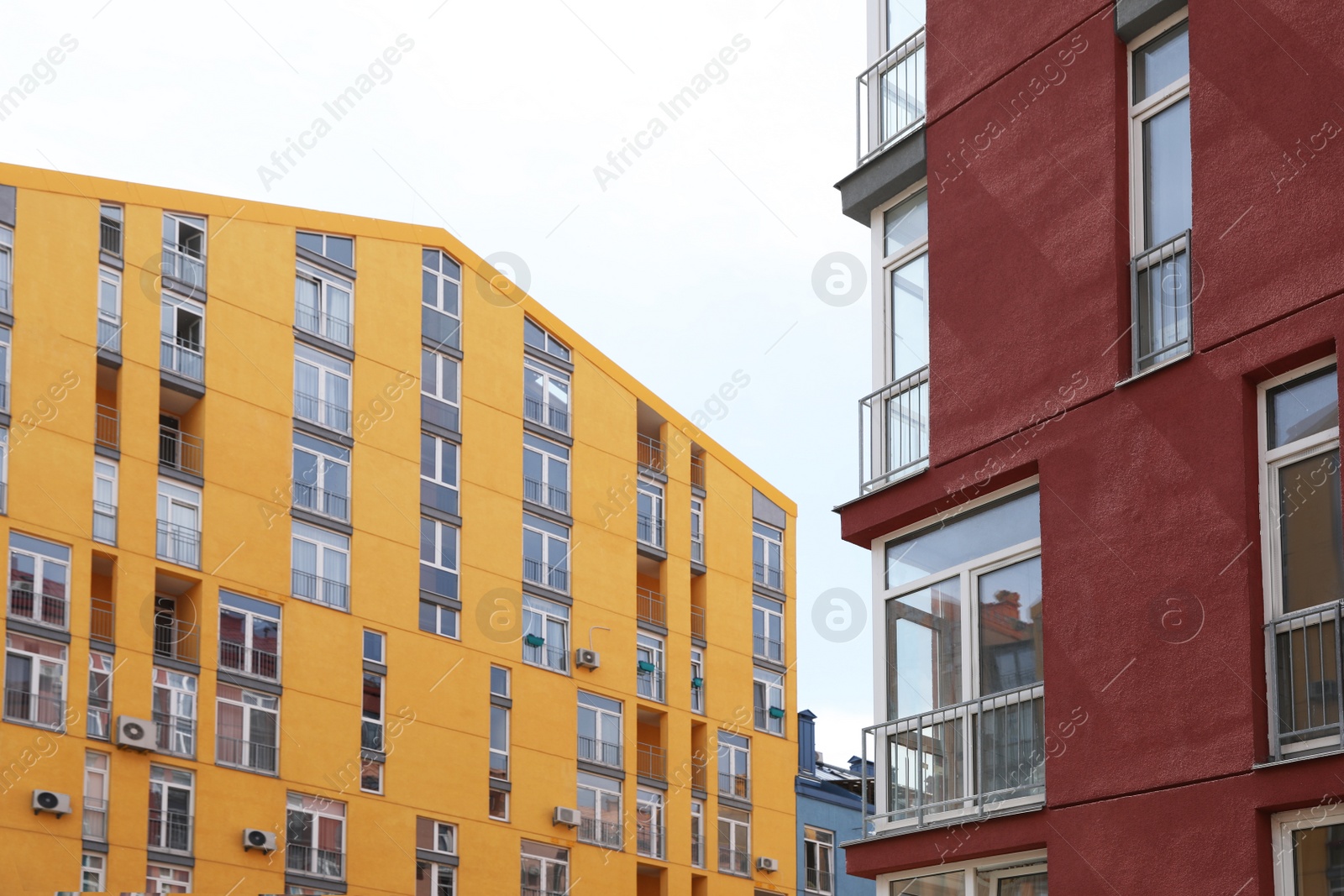 Photo of Colorful modern buildings with windows against sky. Urban architecture