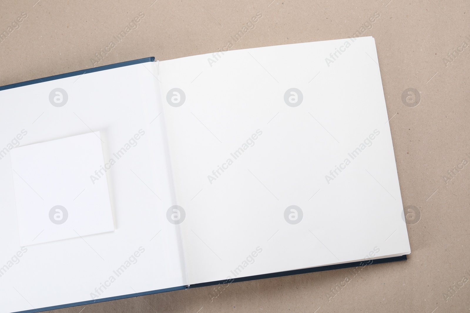 Photo of One open photo album on color background, top view. Space for text