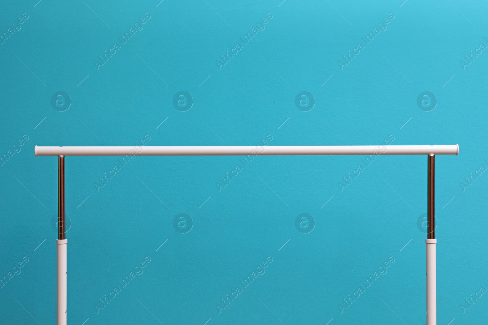 Photo of Empty wardrobe rack for clothing on color background