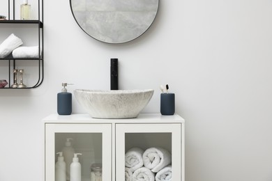 Photo of Different bath accessories, personal care products and bathroom vanity indoors