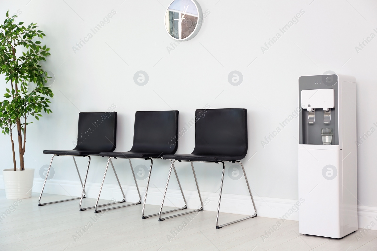 Photo of Modern water cooler in stylish office interior