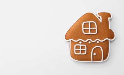 Photo of Christmas house shaped gingerbread cookie on white background, top view