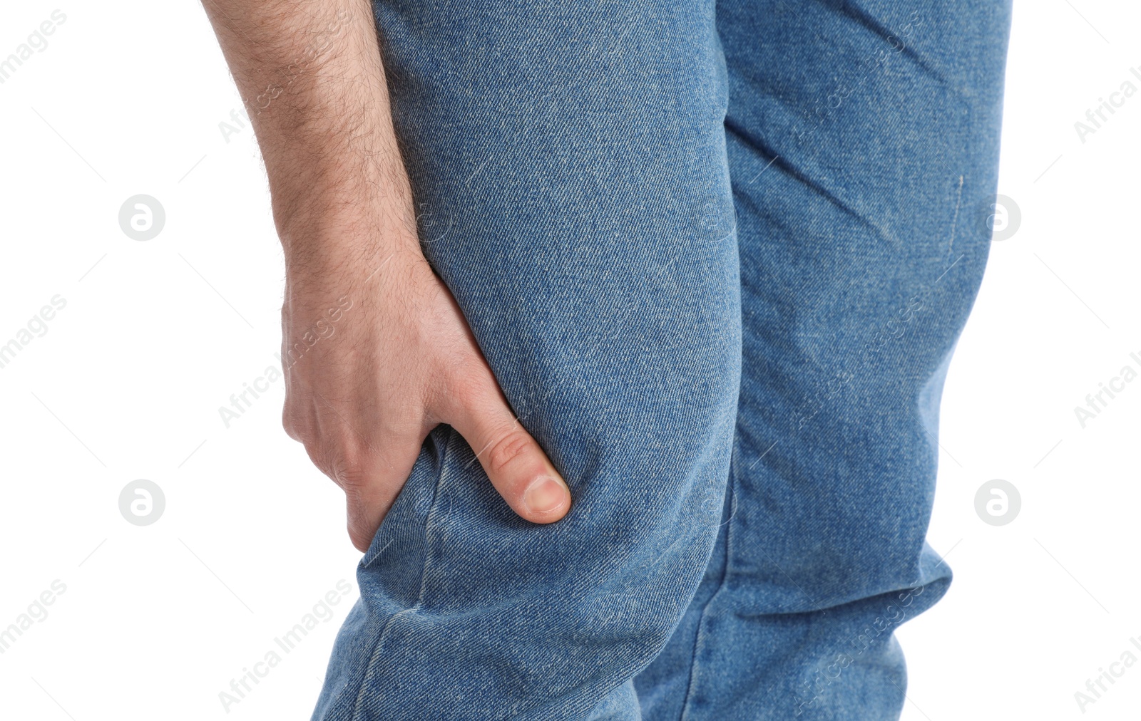 Photo of Young man suffering from leg pain on white background, closeup