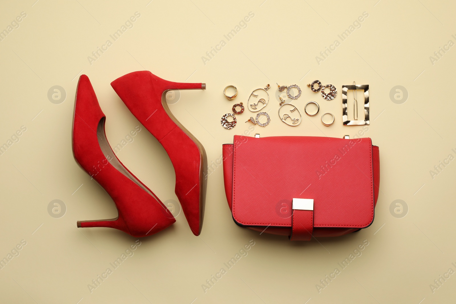 Photo of Stylish woman's bag, shoes and bijouterie on beige background, flat lay