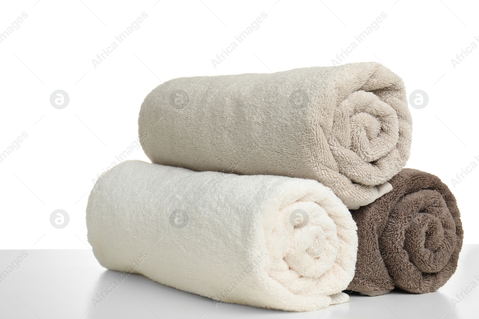 Photo of Rolled soft terry towels on white background