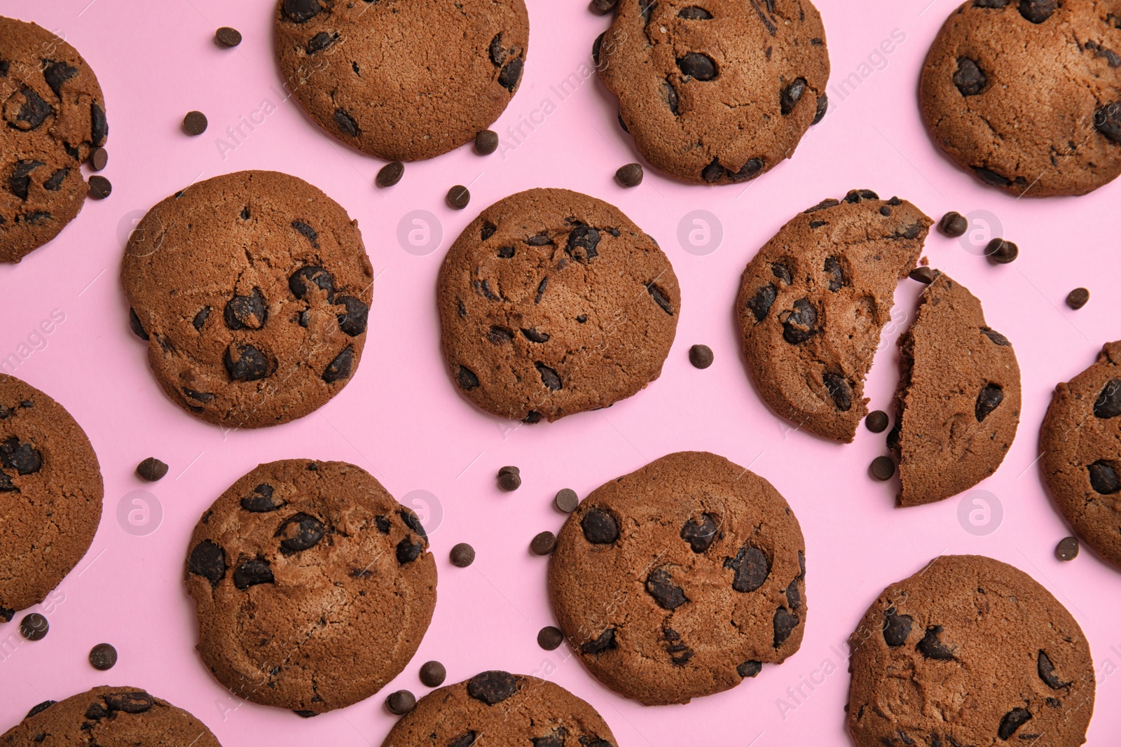 Photo of Delicious chocolate chip cookies on color background, flat lay