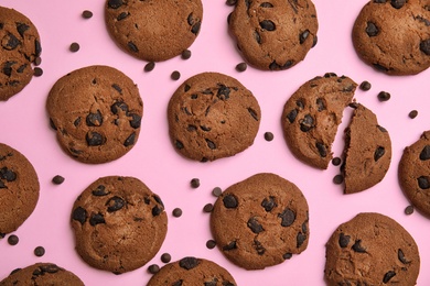 Delicious chocolate chip cookies on color background, flat lay