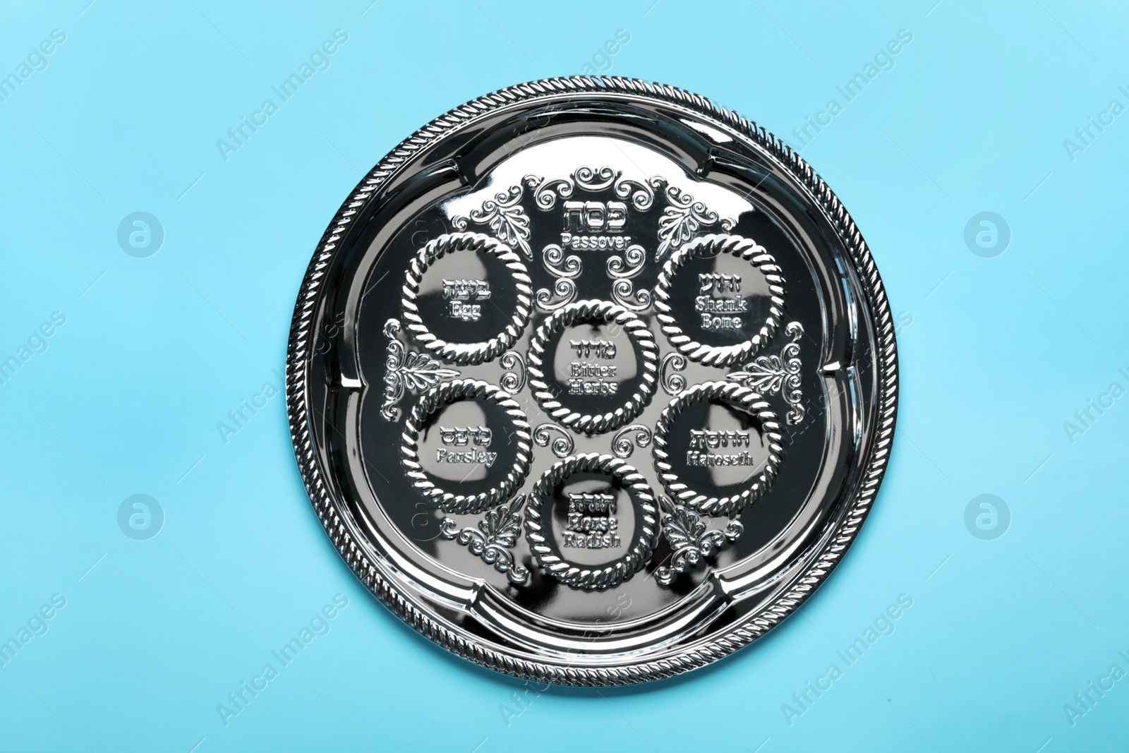 Photo of Empty traditional Passover (Pesach) Seder plate on color background, top view