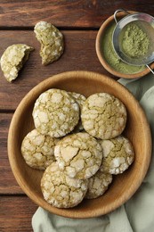 Bowl with tasty matcha cookies and powder on wooden table, flat lay