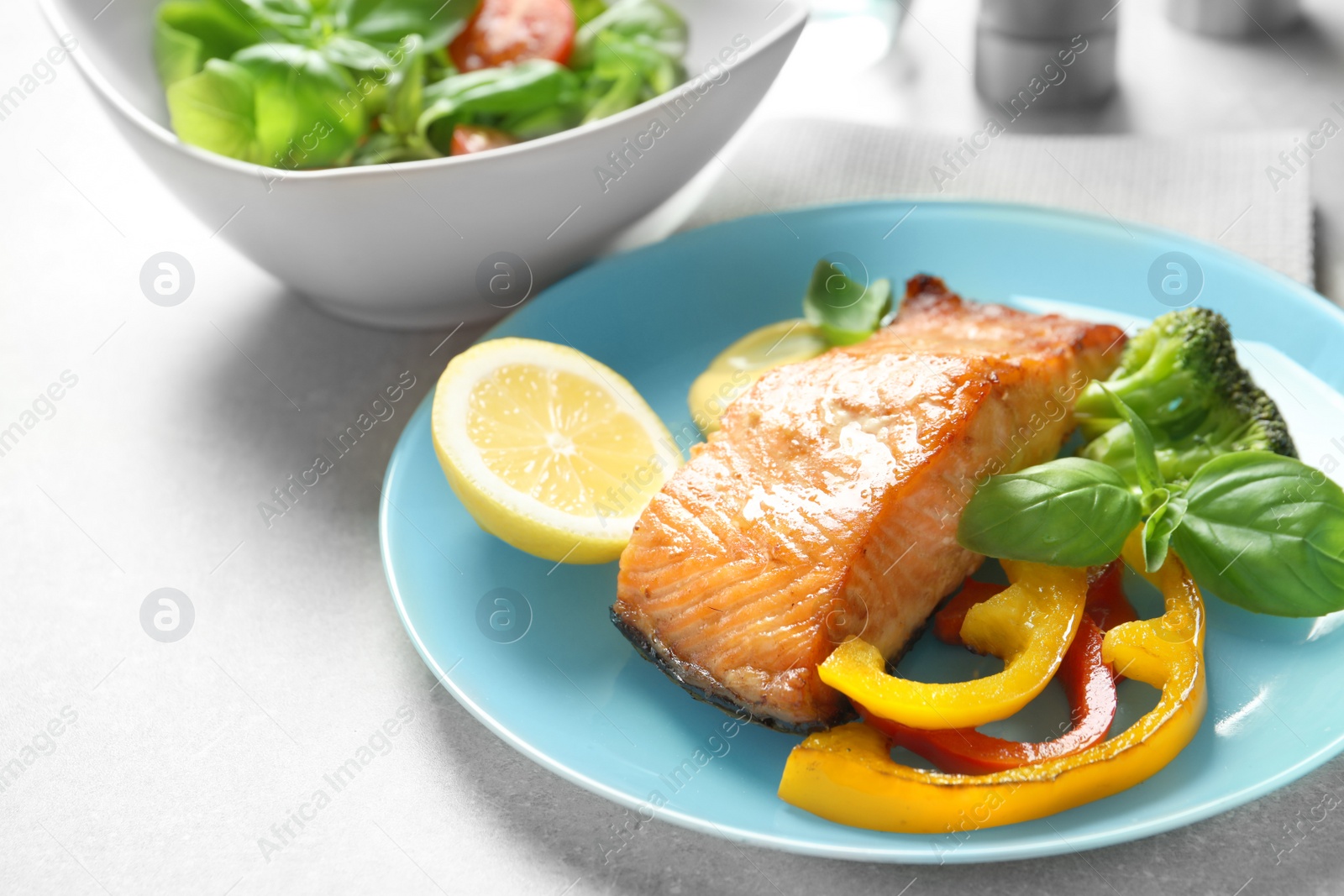 Photo of Tasty cooked salmon with vegetables on plate