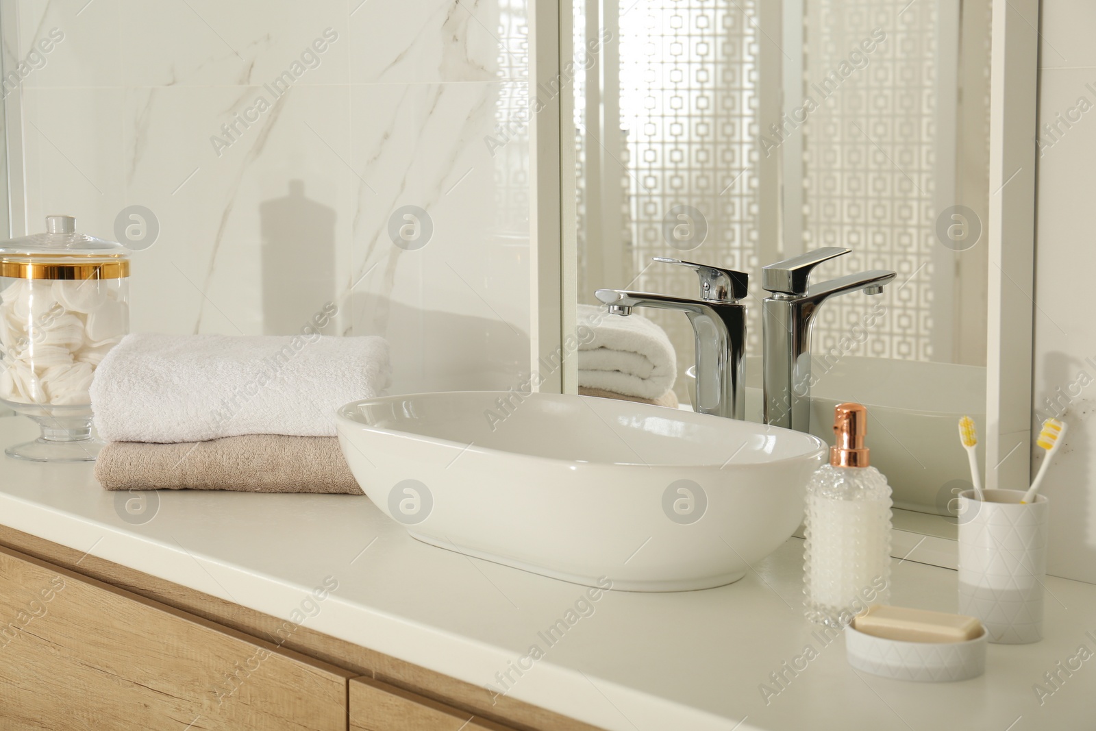 Photo of Large mirror and vessel sink in stylish bathroom