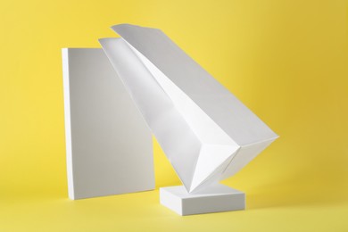 Photo of Presentation of white paper bag on yellow background