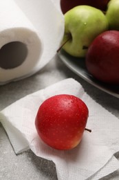 Photo of Paper towel with wet apple on grey textured table