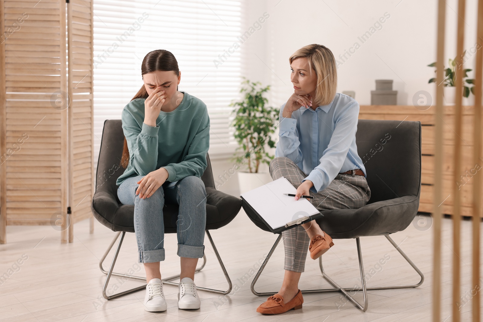 Photo of Professional psychotherapist working with patient in office