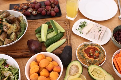 Photo of Healthy vegetarian food and glass of juice on wooden table