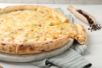 Photo of Delicious cheese pizza on white table, closeup