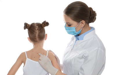 Photo of Doctor examining little girl with chickenpox on white background. Varicella zoster virus
