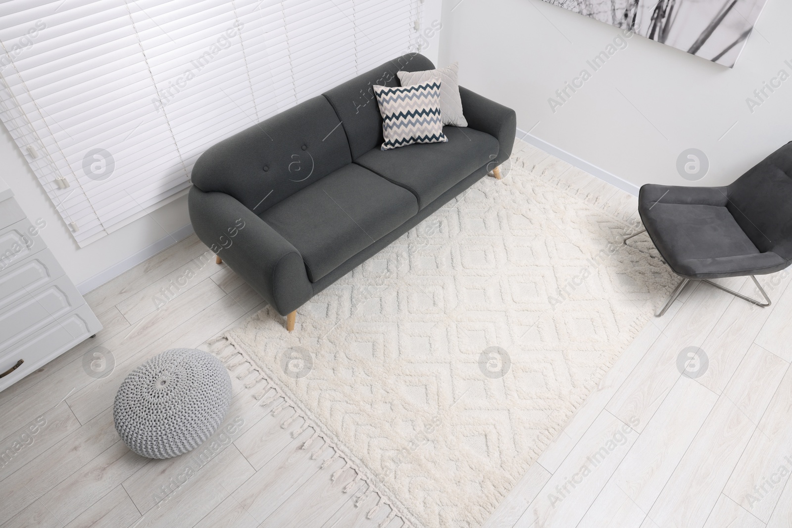 Photo of Living room with soft carpet and stylish furniture, above view. Modern interior