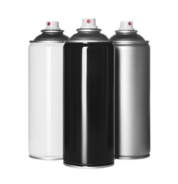 Photo of Cans of spray paints on white background