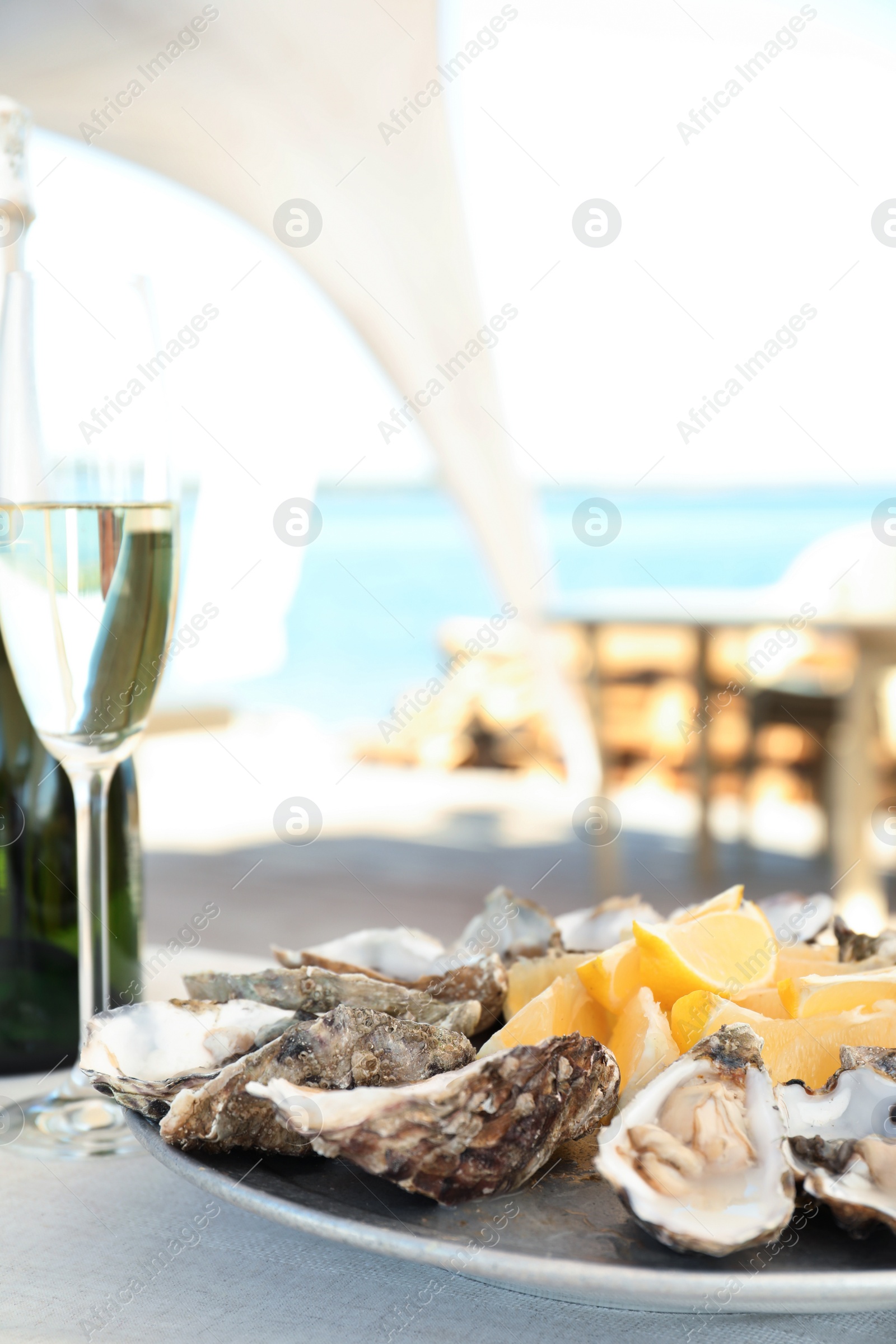 Photo of Fresh oysters with cut juicy lemon served on table