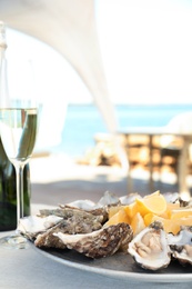 Fresh oysters with cut juicy lemon served on table