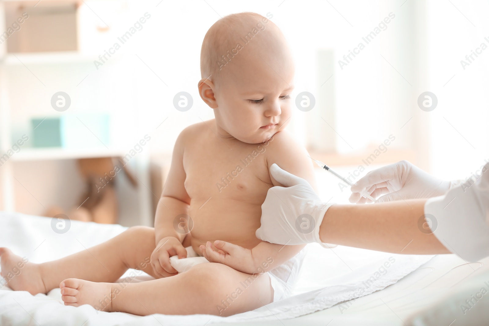 Photo of Doctor vaccinating baby in clinic