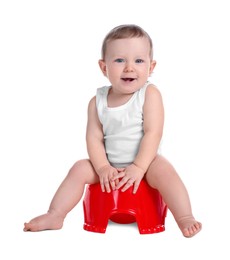 Photo of Little child sitting on baby potty against white background