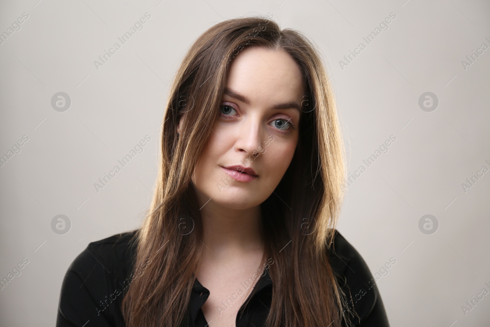 Photo of Portrait of beautiful young woman on beige background