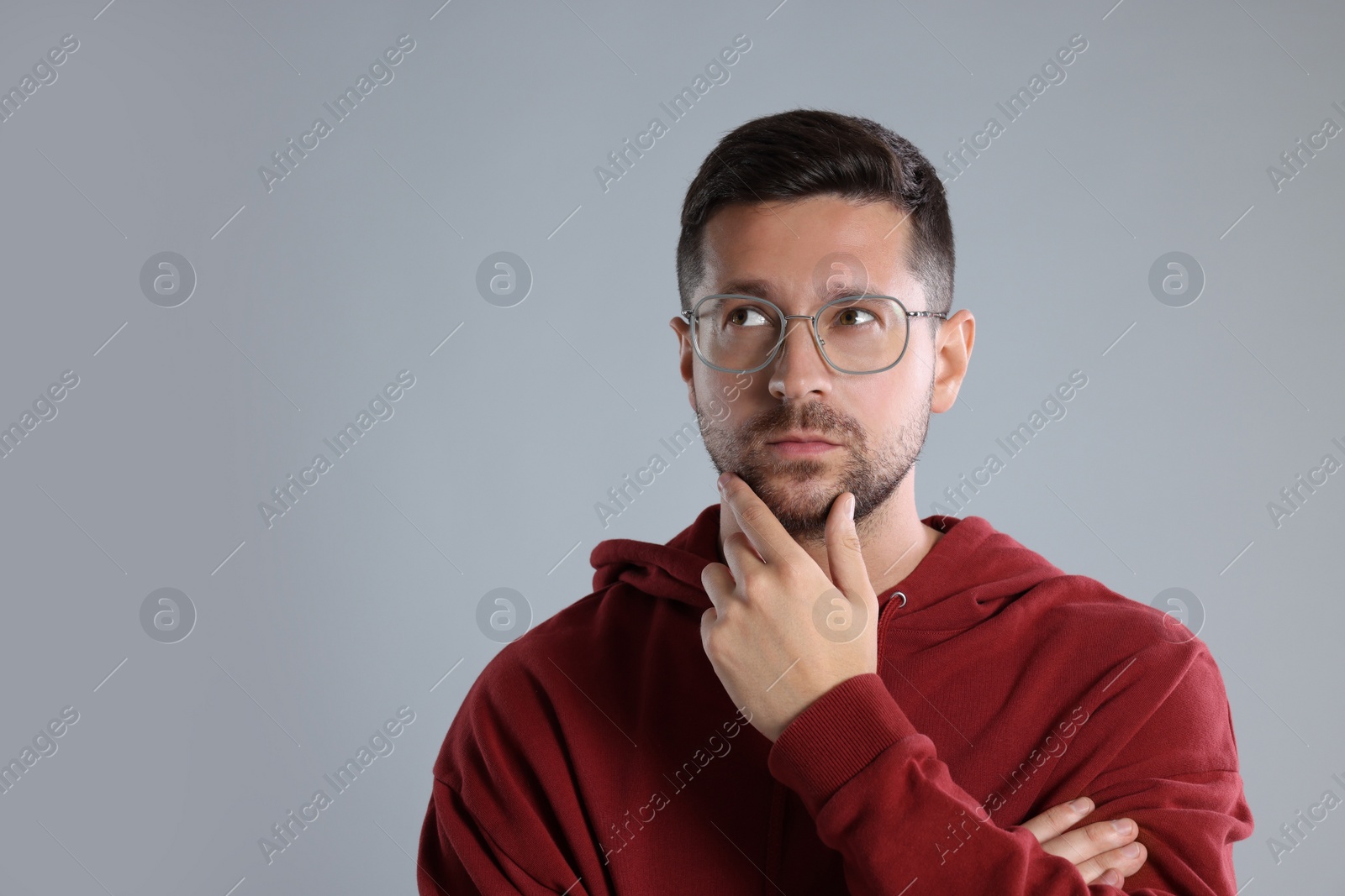 Photo of Portrait of man in stylish glasses on light grey background. Space for text