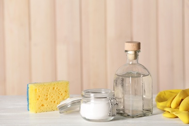 Photo of Composition with vinegar, baking soda and cleaning supplies on table